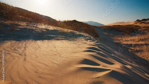 Sandy dunes near the town of Joaquina at sunset on the island of Santa Catarina in Brazil photo