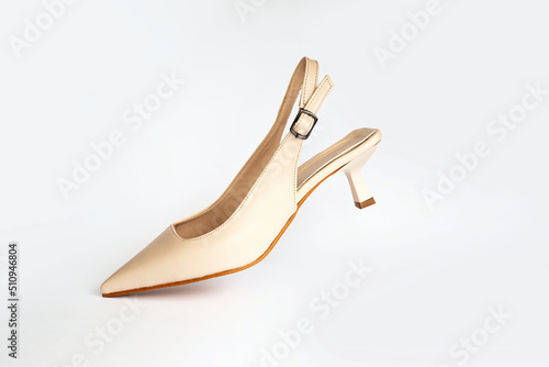 Beige short heels isolated on white background. Fashion concept, catwalk. A modern and trendy shoe store.
