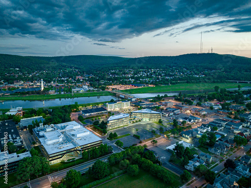 Photography Late afternoon, early evening aerial image of Corning NY looking southwest towar