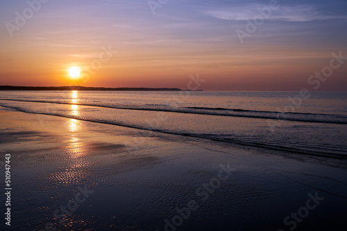 sunset on a sandy beach on the Baltic sea in the evening