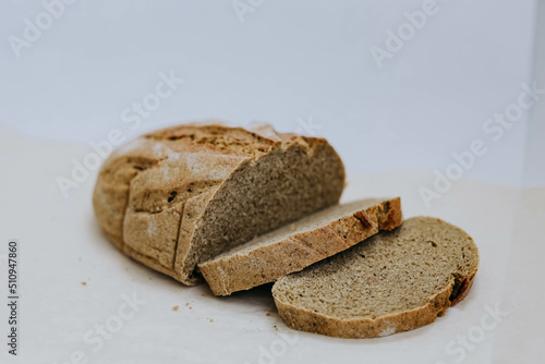 Homemade freshly baked rye and wheat loaf of bread on white background. Concept of health and huger. Organic Food concept, photo  with copy space, close up photo