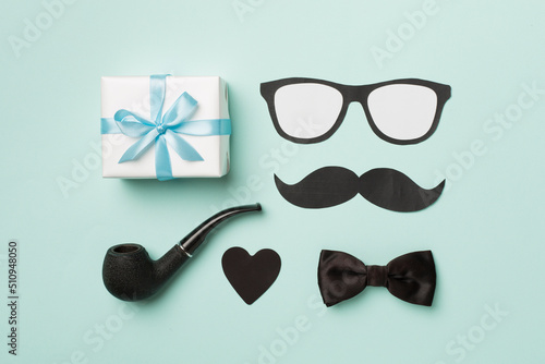 Father's Day accessories on color background, top view