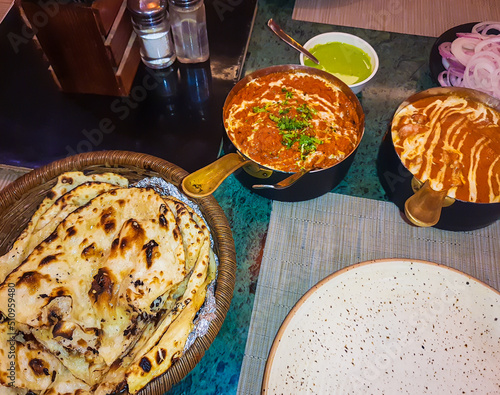 delicious indian dishes with tandoori bread served at dinner from different angle