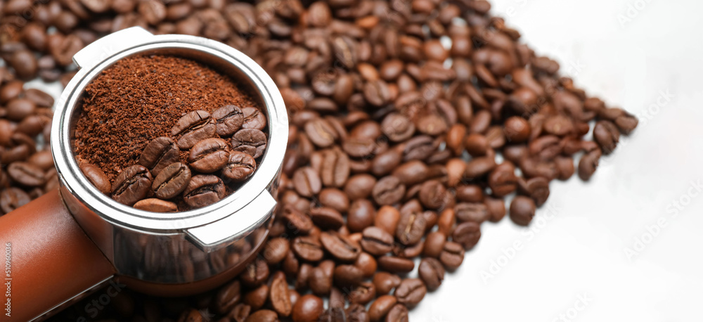 Fototapeta premium Portafilter with coffee powder and beans, closeup