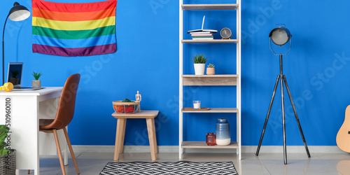 Fotografia Interior of modern room with rack, workplace and LGBT flag