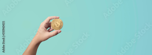 man holding a bitcoin in his hands on blue background