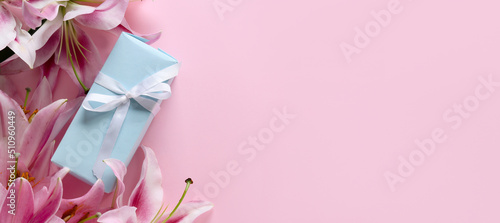 Photography Beautiful lilies and gift box on pink background with space for text