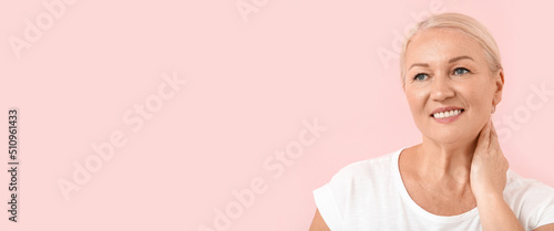 Happy mature woman on pink ...