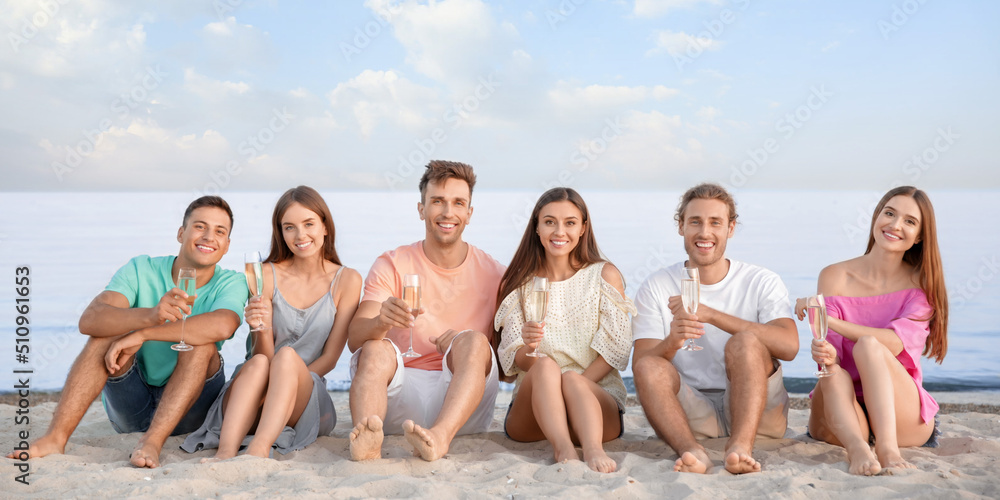 Friends drinking champagne on sea beach Friends drinking champagne on sea beach