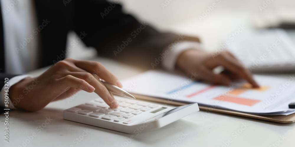 Fototapeta premium Asian Accountant checking tax and using calculator. Anti Bribery concept.