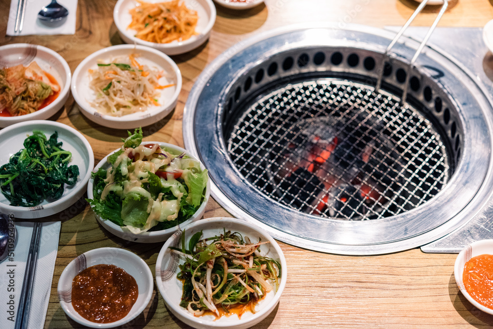 Spicy Kimchi group. Korean pickle or Pickled radish vegetables set and seasoning on bowl on stove serve wood table background, Japanese food