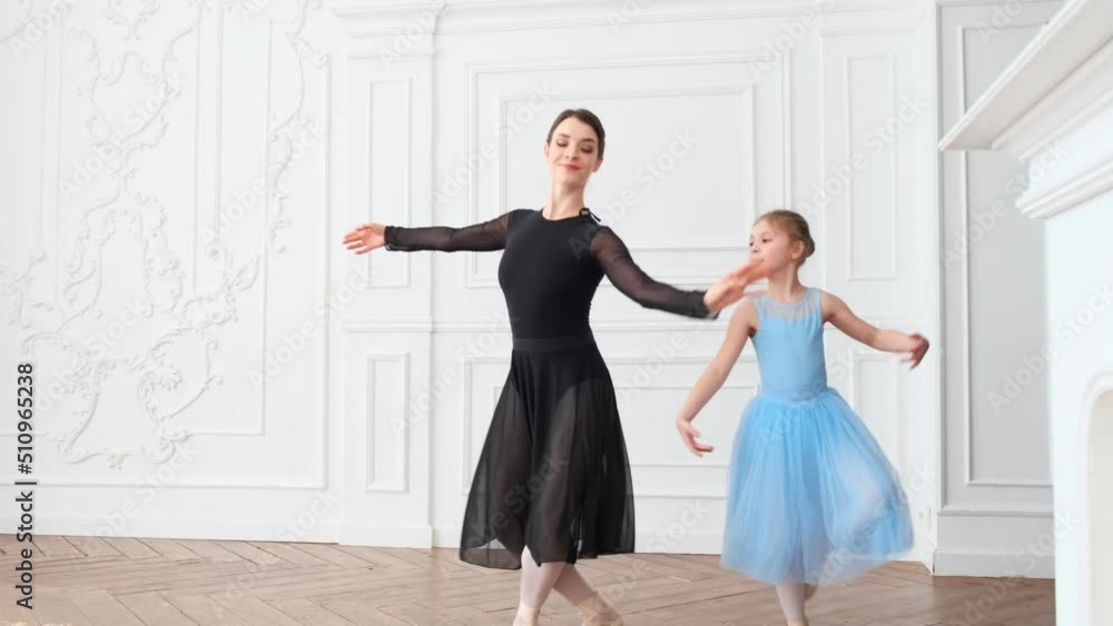 Young girls from ballet dancing ballet in white studio. Pretty graceful ballerinas doing elements of classical ballet - arts concept 4k footage Young girls from ballet dancing ballet in white studio. Pretty graceful ballerinas doing elements of classical ballet - arts concept 4k footage