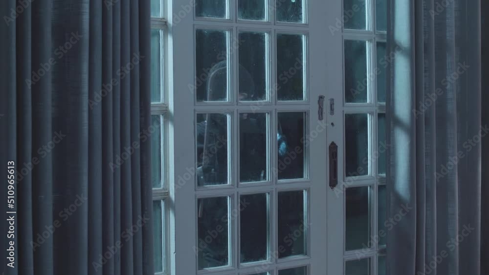 Thief Man Holding Flashlight And Using Crowbar Open The Door Before Entering Someone'S House 
