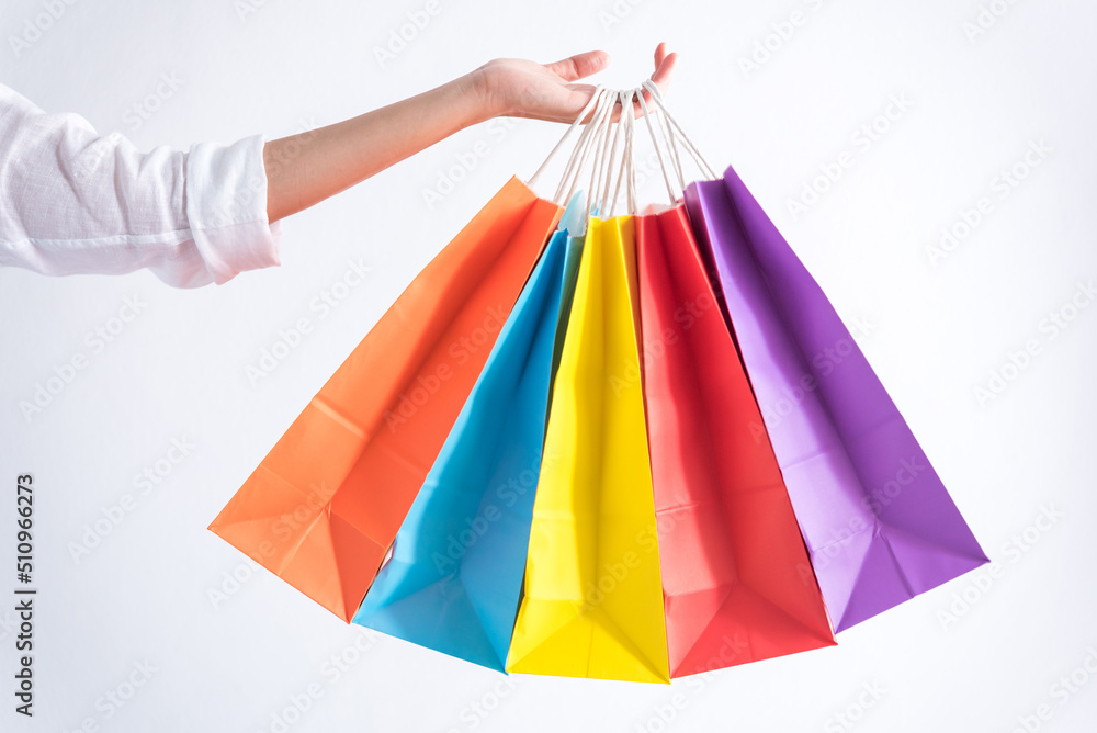woman hand holding many color of shopping bag