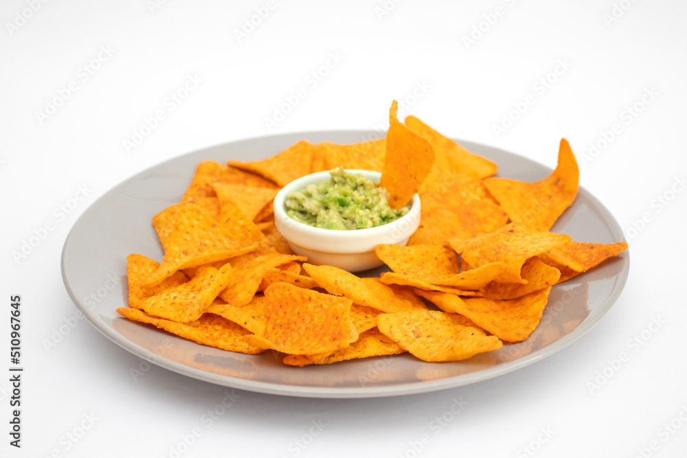 Bowl with guacamole and nachos on white background, isolated Bowl with guacamole and nachos on white background, isolated