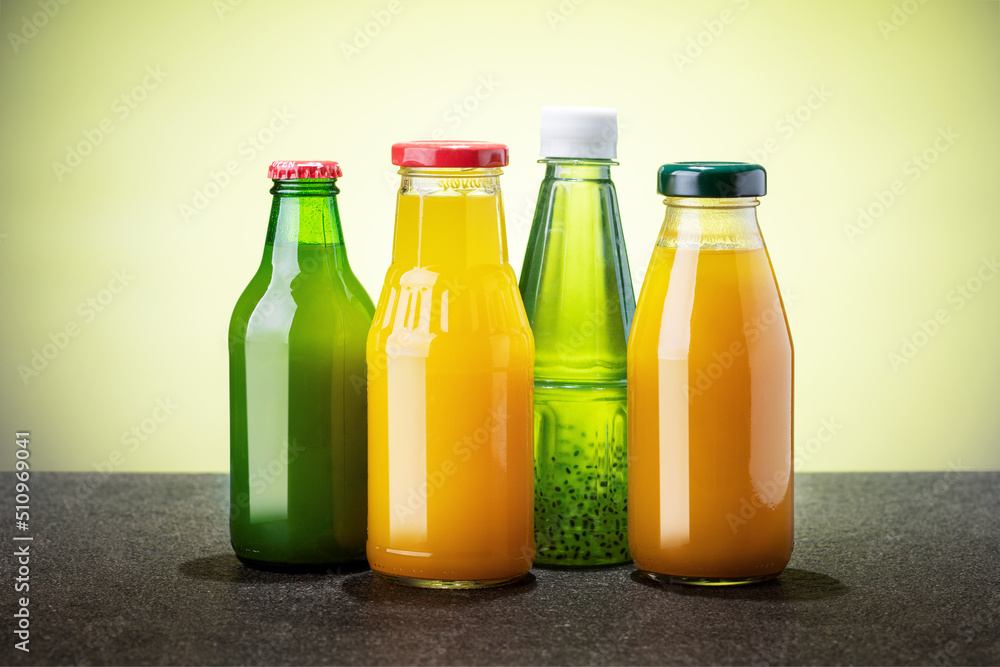 Glass bottles of various fruit juices. Summer drinks. Glass bottles of various fruit juices. Summer drinks.