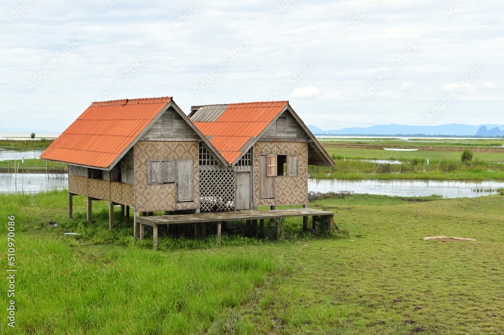 Abandoned house with orange roof located in Thale Noi area the part of Songkhla Lake, Phatthalung, THAILAND. Abandoned house with orange roof located in Thale Noi area the part of Songkhla Lake, Phatthalung, THAILAND.