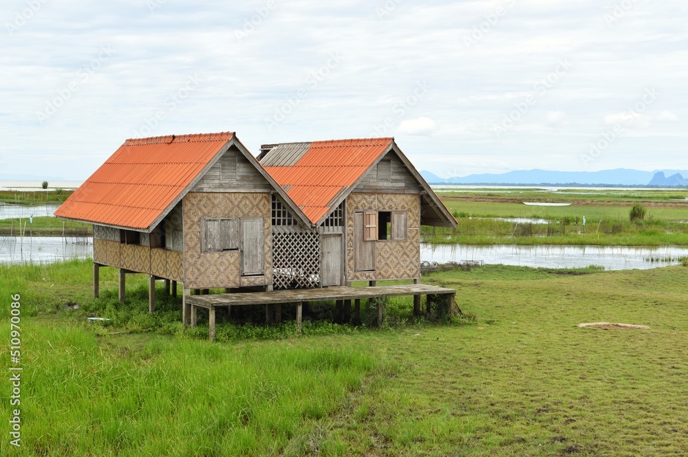 Abandoned house with orange roof located in Thale Noi area the part of Songkhla Lake, Phatthalung, THAILAND.