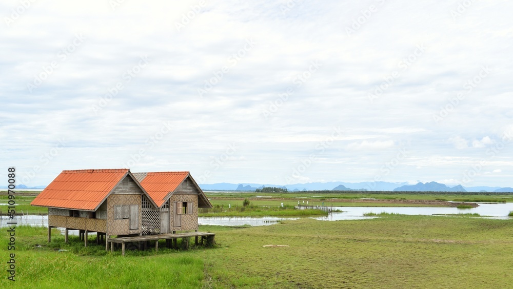 Obraz premium Abandoned house with orange roof located in Thale Noi area the part of Songkhla Lake, Phatthalung, THAILAND.