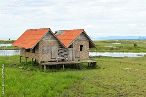 Abandoned house with orange roof located in Thale Noi area the part of Songkhla Lake, Phatthalung, THAILAND. © PRANGKUL