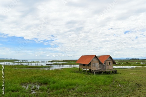 Abandoned house with orange roof located in Thale Noi area the part of Songkhla Lake, Phatthalung, THAILAND.