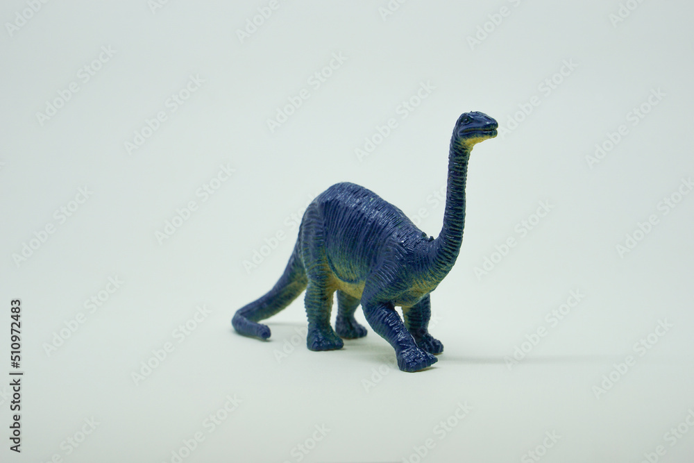 Side view of plastic brontosaurus dinosaur plastic toy for kids, isolated on a studio lighting background Side view of plastic brontosaurus dinosaur plastic toy for kids, isolated on a studio lighting background