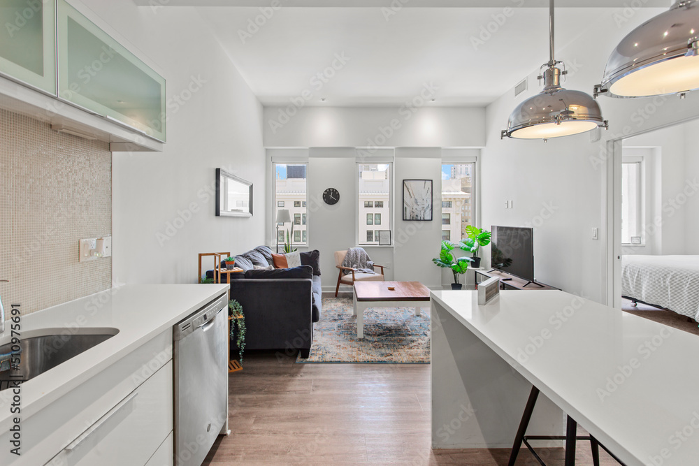 beautiful kitchen in new luxury home with island, pendant lights, hardwood floors, and stainless steel appliances beautiful kitchen in new luxury home with island, pendant lights, hardwood floors, and stainless steel appliances