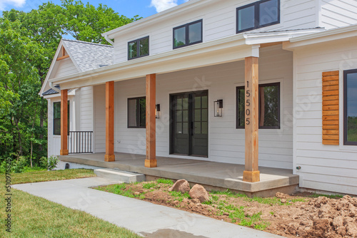 Fotografie Brand new construction farmhouse style white home exterior