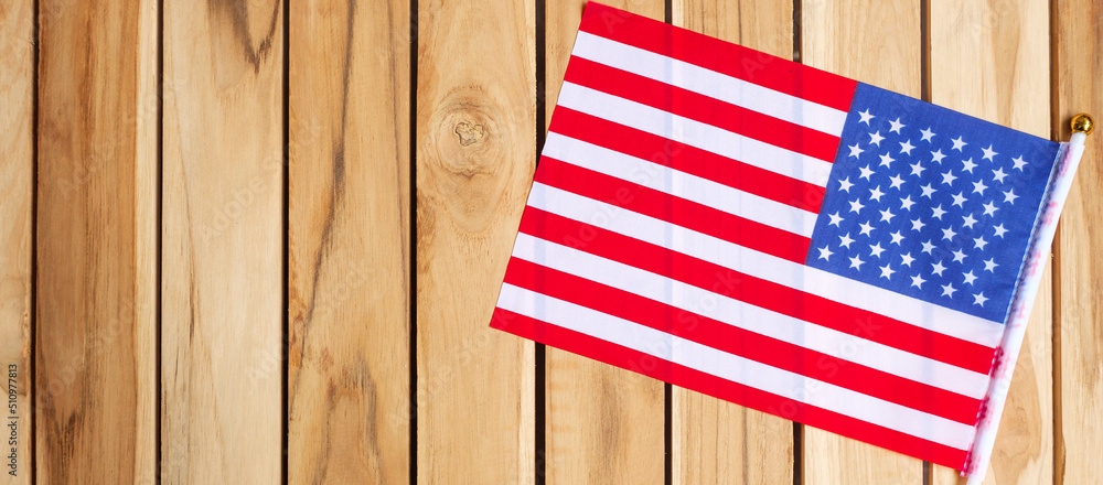 Obraz premium United States of America flag on wooden table background. USA holiday of Veterans, Memorial, Independence ( Fourth of July) and Labor Day concept