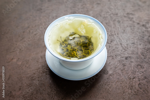 Cup of green tea on a stone table close-up high angle iew photo