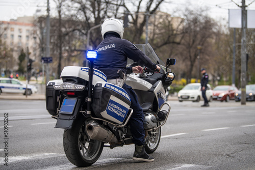 Policeman on motorcycle patrol on the street. Translation   Police 