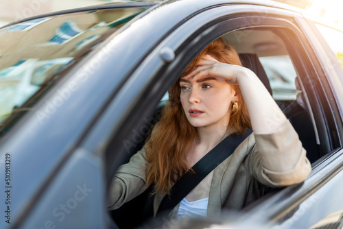 Nervous female driver sits at wheel, has worried expression as afraids to drive car by herself for first time. Frightened woman has car accident on road. People, driving, problems with transport © Graphicroyalty