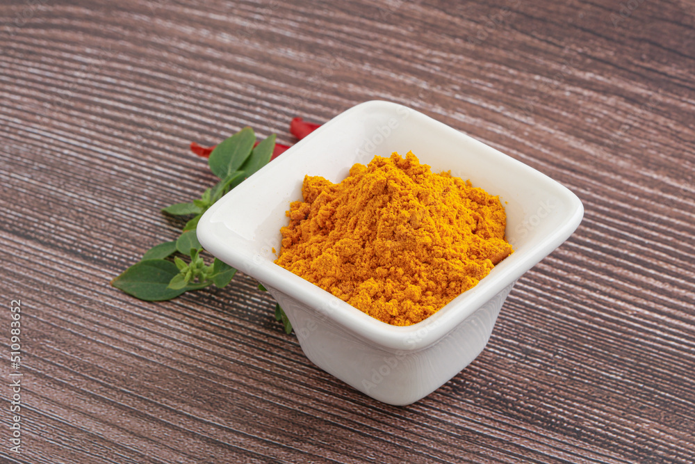 Yellow vibrant curcuma powder in the bowl Yellow vibrant curcuma powder in the bowl