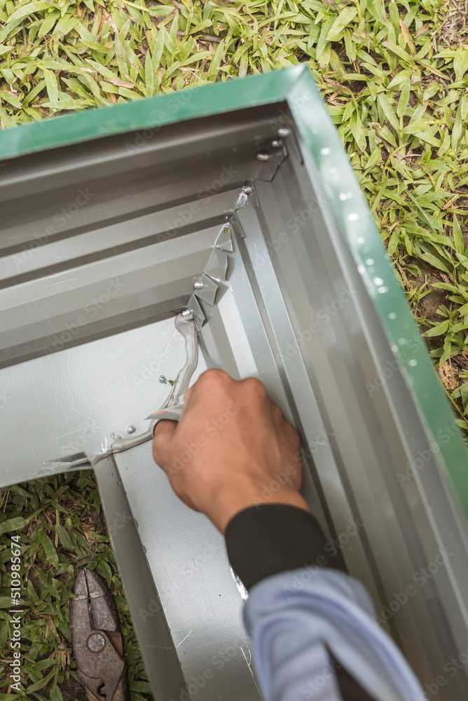 Using metal epoxy to seal the joints between two pieces of gutter. Roof