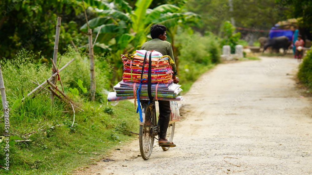 Fototapeta premium rural man selling some items from cycle