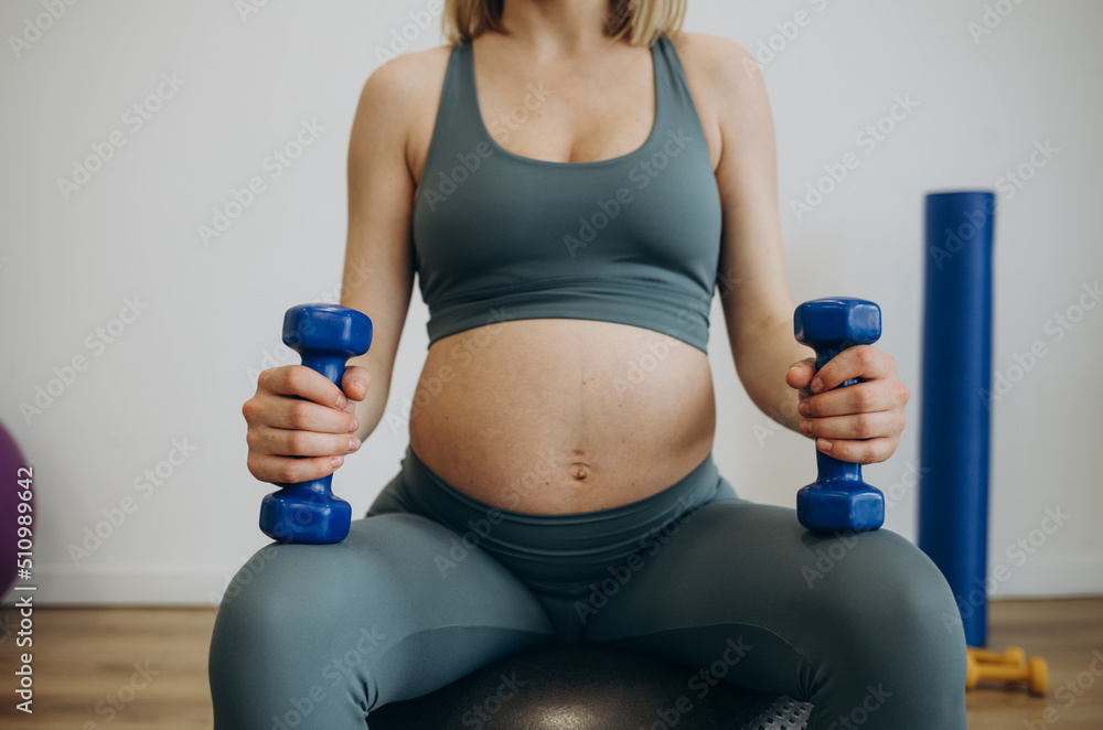 Pregnant woman practicing yoga at home Pregnant woman practicing yoga at home