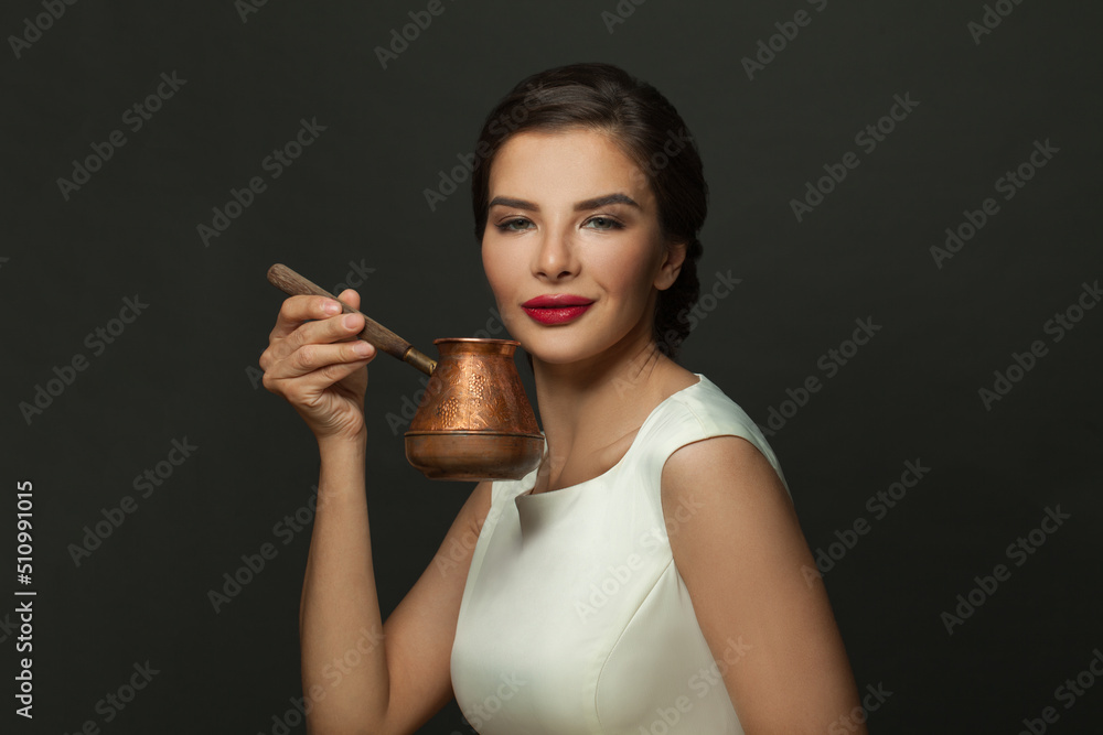 Coffee lover. Beautiful young woman holding coffee in turk cezve ibric on black background Coffee lover. Beautiful young woman holding coffee in turk cezve ibric on black background