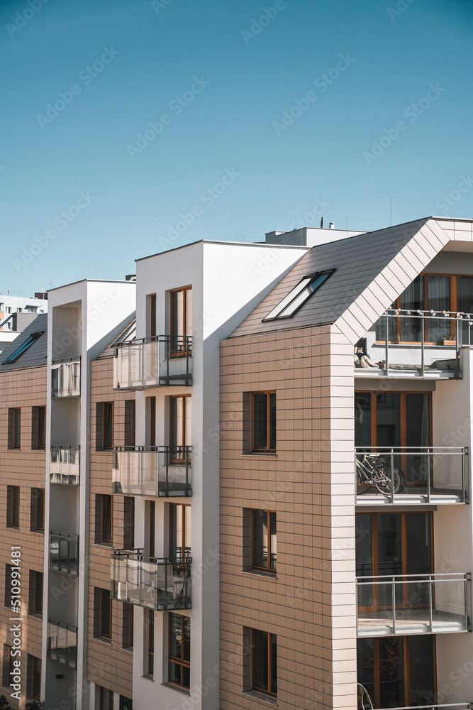 Exterior of a modern condominium. Residential area with ecological and sustainable green residential buildings, low-energy houses with apartments and green courtyard