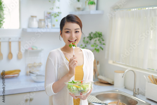 woman is eating a salat in bowl, indoor