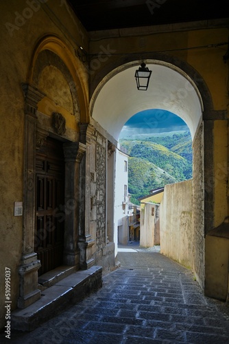 A narrow street between the old houses of Teggiano, a medieval village in the mountains of Salerno province, Italy. © Giambattista
