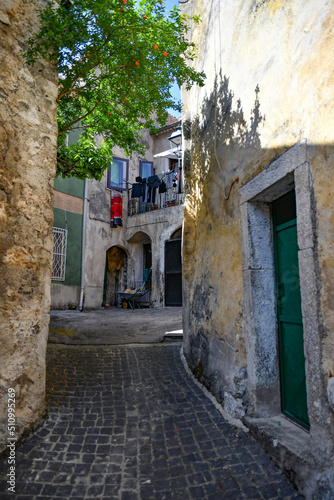 A narrow street between the old houses of Teggiano, a medieval village in the mountains of Salerno province, Italy. © Giambattista