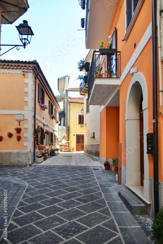 A narrow street between the old houses of Teggiano  a medieval village in the mountains of Salerno province  Italy.