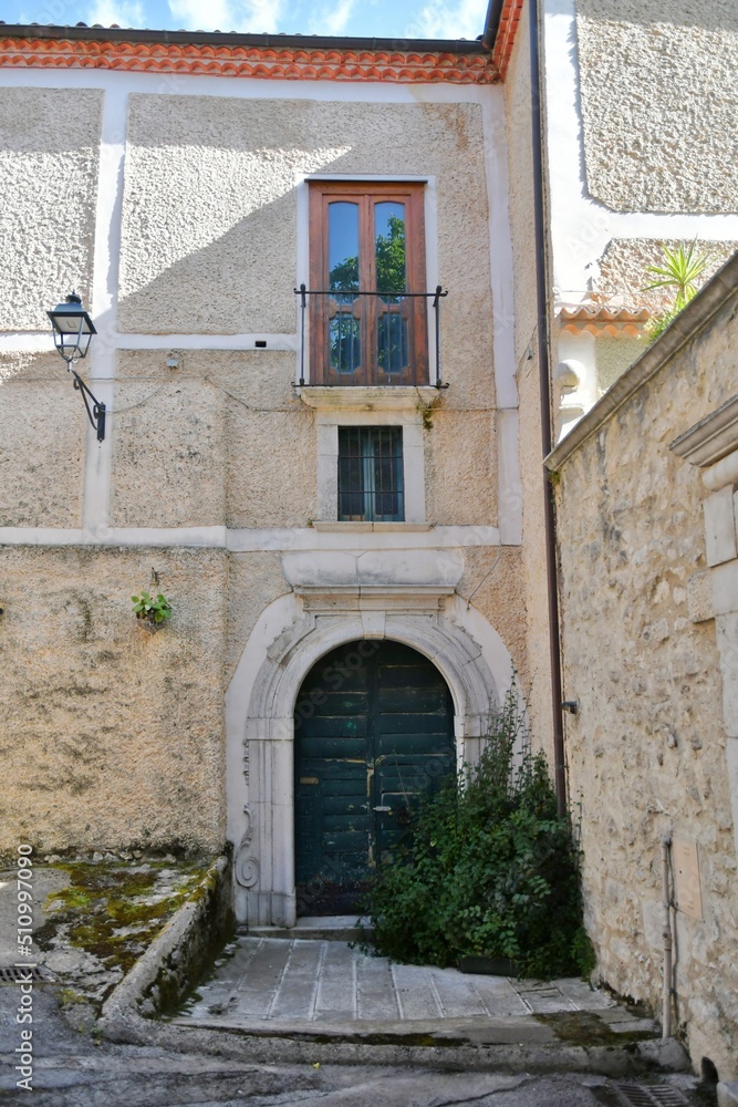 The facade of an old house in Teggiano, a medieval village in the mountains of Salerno province, Italy.