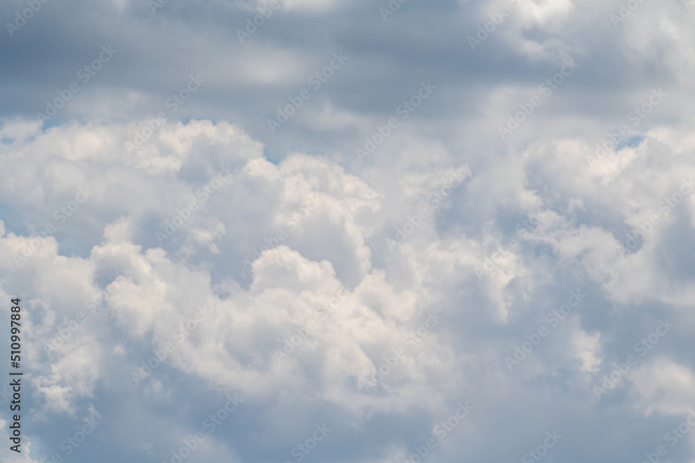 White clouds on the blue sky, bright background of the summer sky. White clouds on the blue sky, bright background of the summer sky.