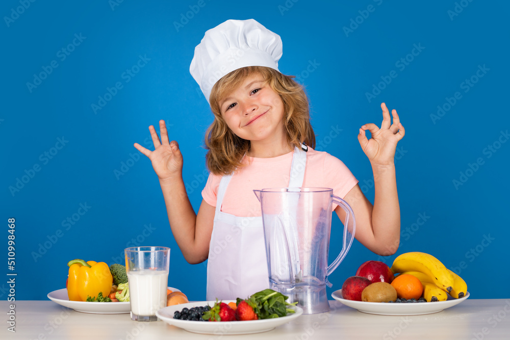 Portrait of chef child in cook hat. Cooking at home, kid boy preparing food from vegetable and fruits. Healthy eating. Fruits and vegetables for kids. Portrait of chef child in cook hat. Cooking at home, kid boy preparing food from vegetable and fruits. Healthy eating. Fruits and vegetables for kids.