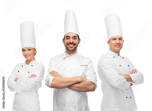 cooking, culinary and profession concept - team of smiling chefs with crossed arms
