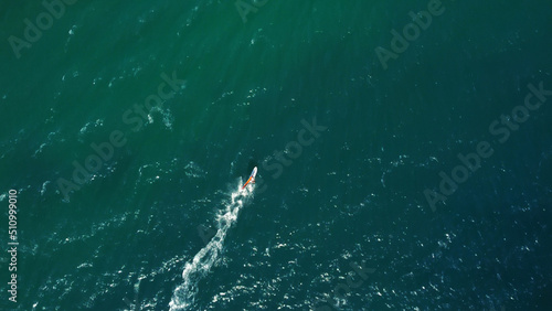 Aerial drone view of windsurfer enjoying on blue sea ocean waves..