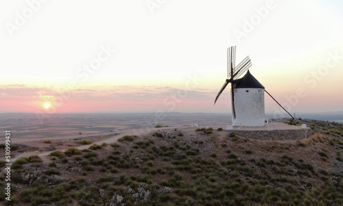 Sunrise with a windmill in a hill in Consuegra. La Mancha. Don Quixote. Spain