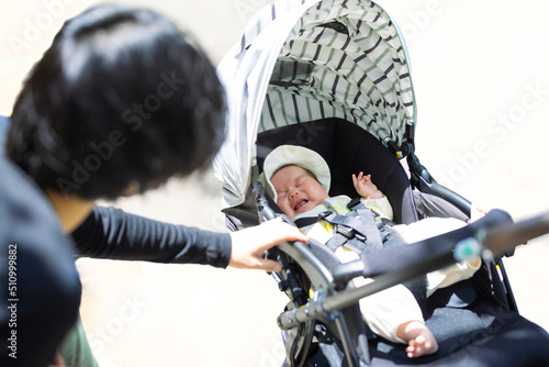 Baby in stroller. A baby crying with an empty tail length and its mother. photo