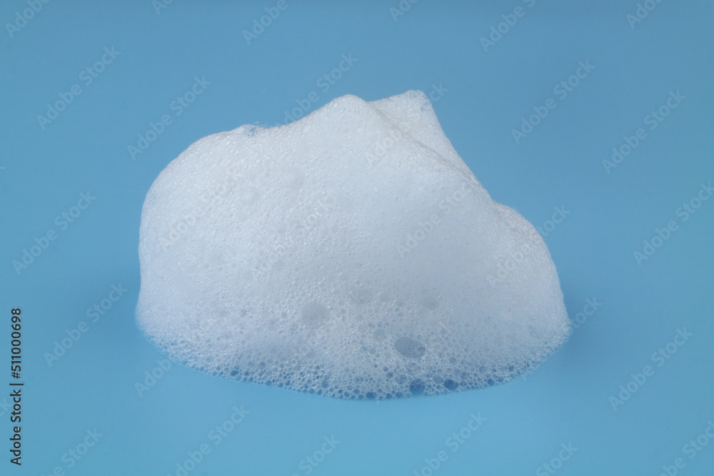 Soap or shampoo foam bubbles on blue background. Wash, clean and health care concept. Soap or shampoo foam bubbles on blue background. Wash, clean and health care concept.